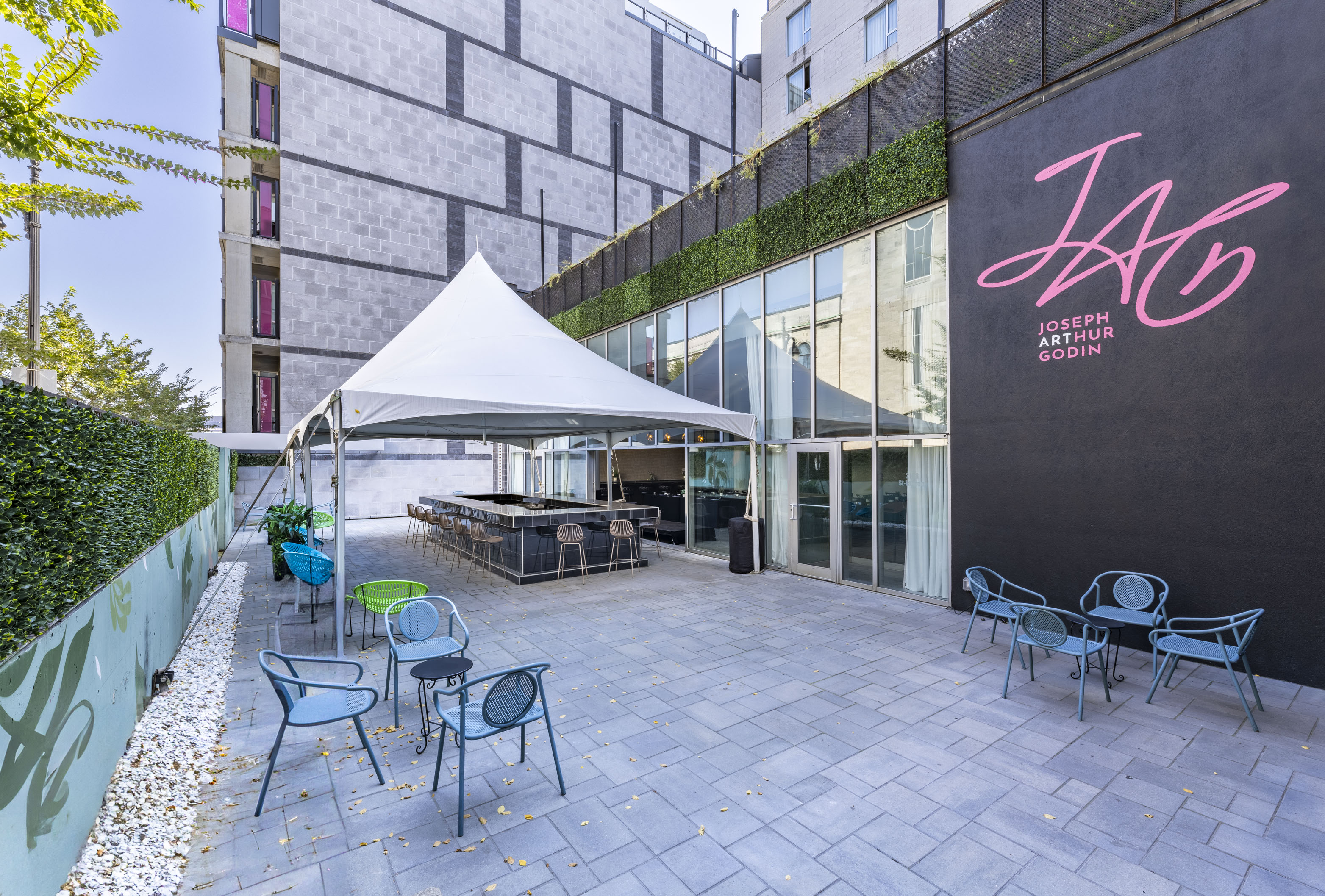 a patio with a white tent and chairs