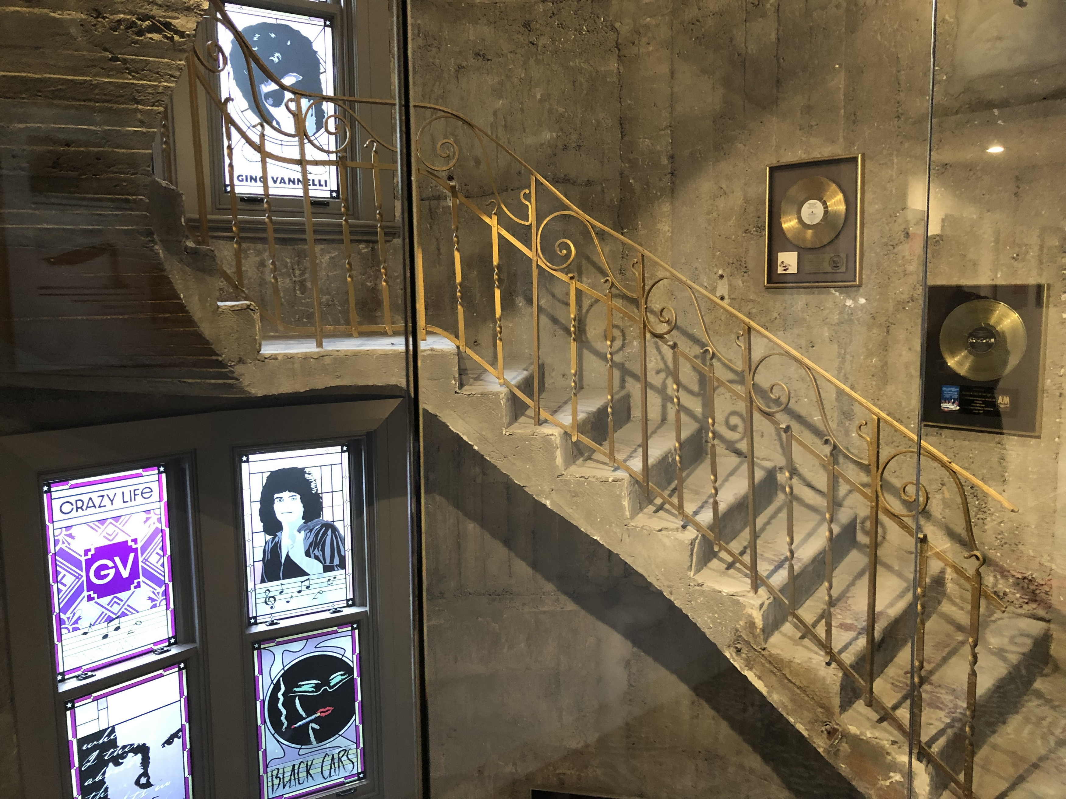 a staircase with a gold railing